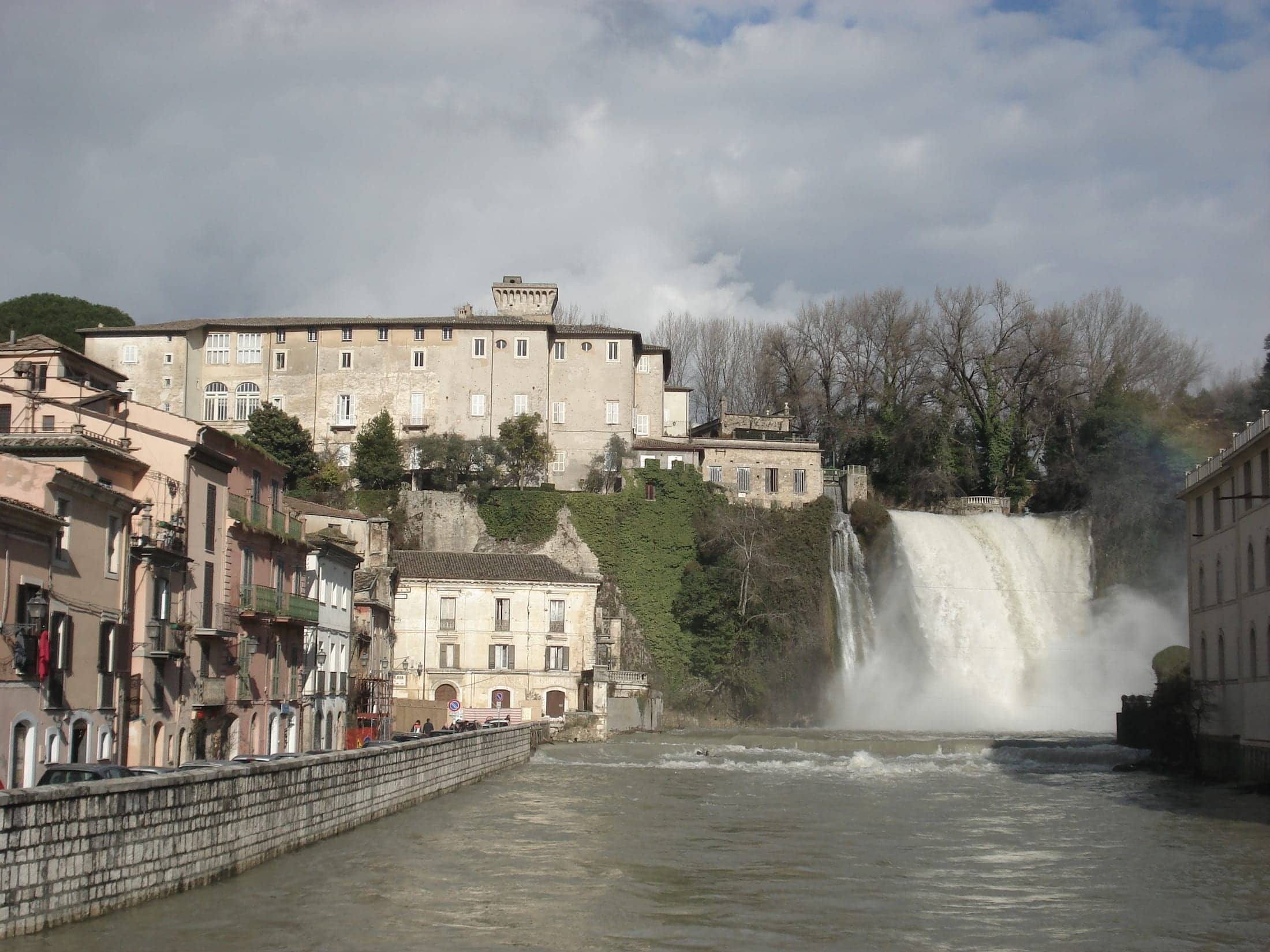 Castello Boncompagni Viscogliosi, Isola del Liri, Lazio: exterior, the castle on its travertine rock above the Cascata Grande, with the riverside town in the lower frame.