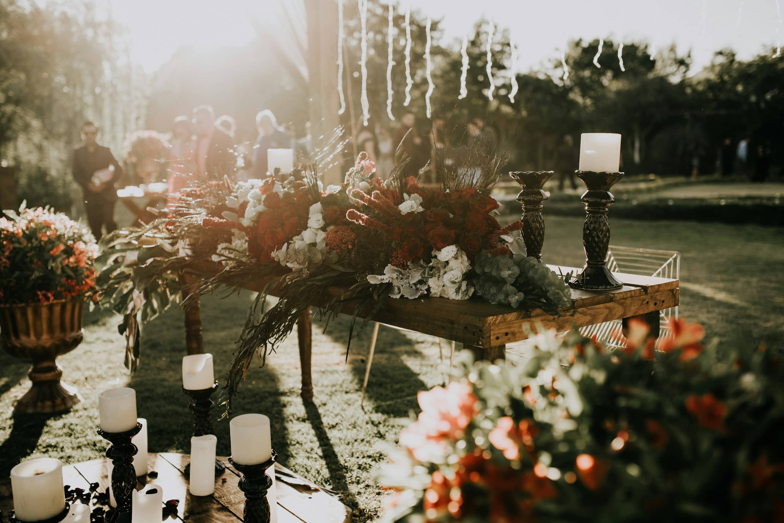 A wedding table dense with flowers and candlelight.